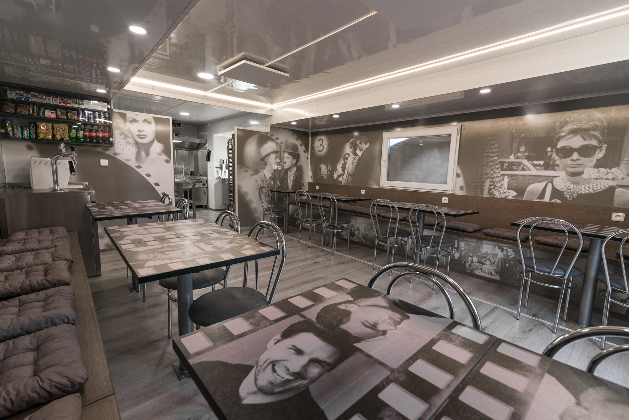 The completed catering truck interior — film collages on walls, tables and benches.