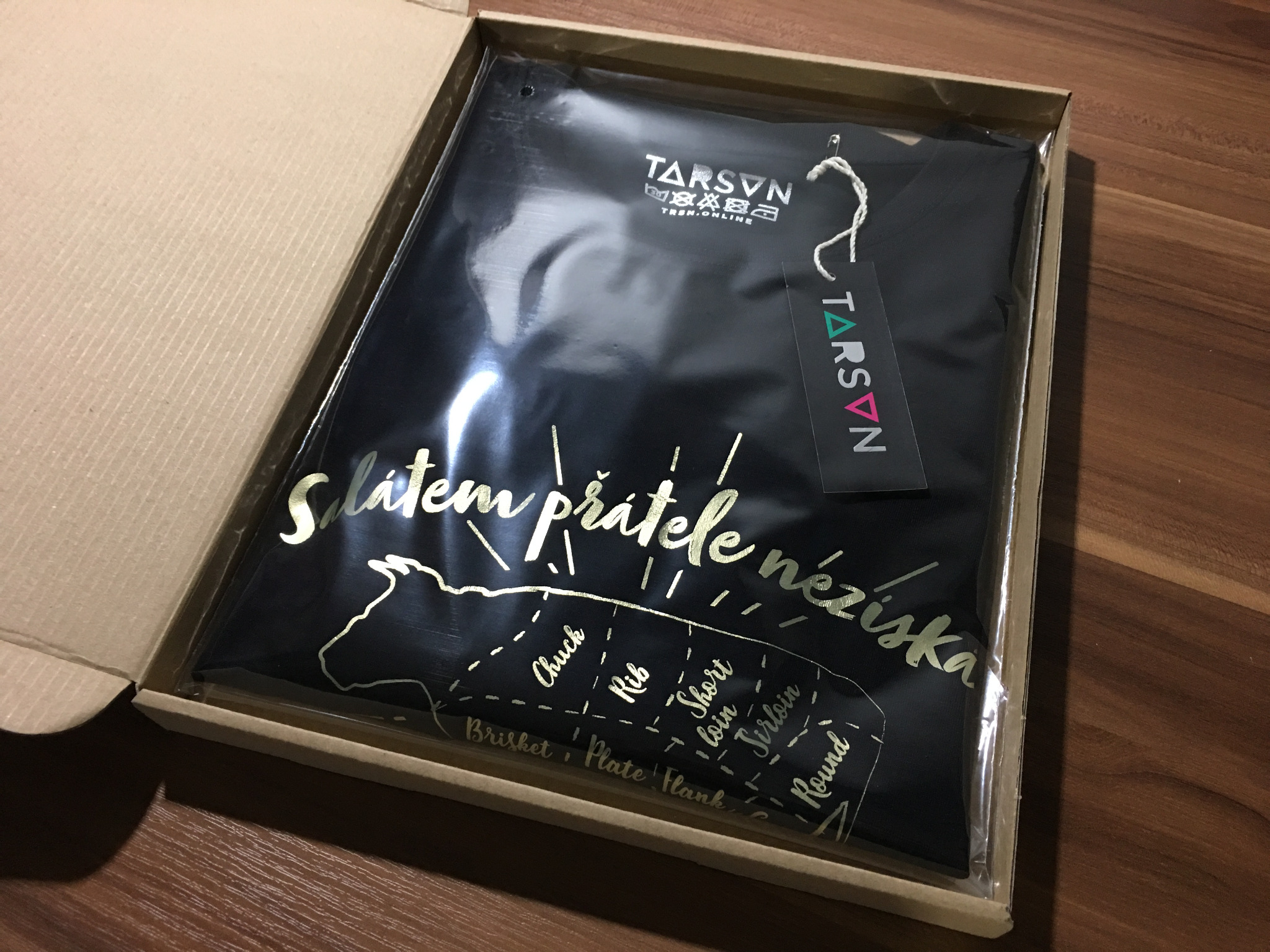 Finished T-shirt packaging with a swing tag and branding